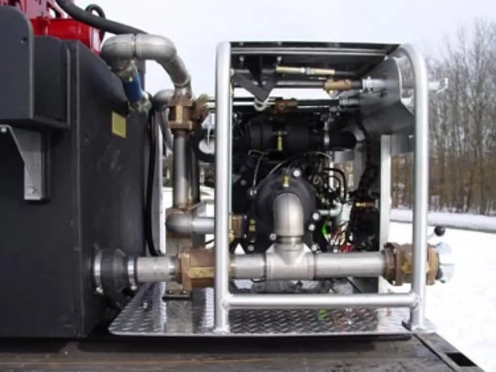 Exterior view of small fire truck showing cab, body compartments, and wheel/tire area.