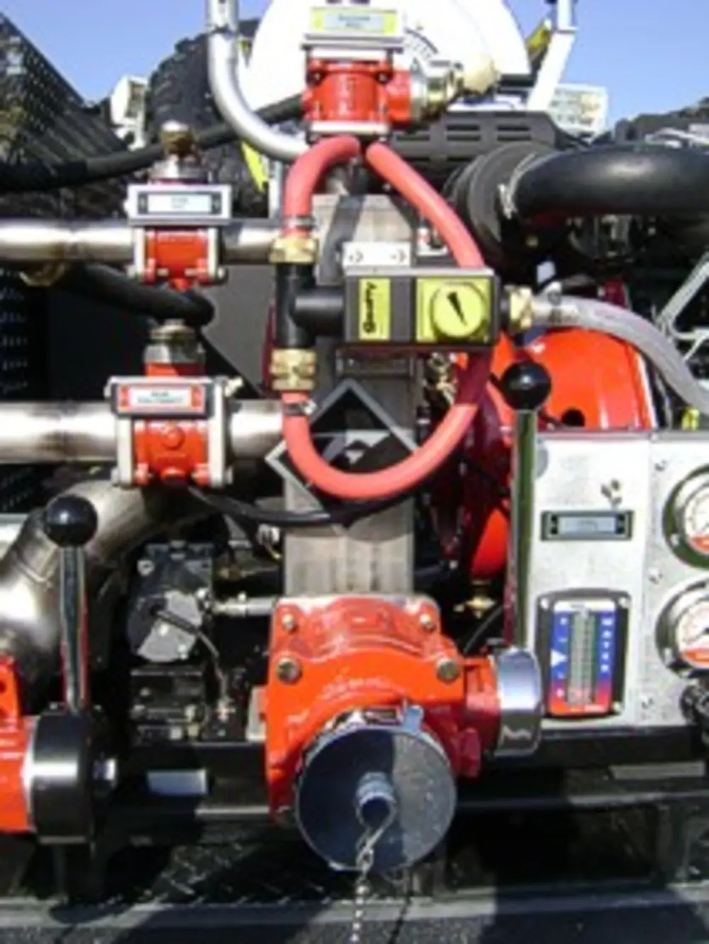 Exterior view of small fire truck showing cab, body compartments, and wheel/tire area.