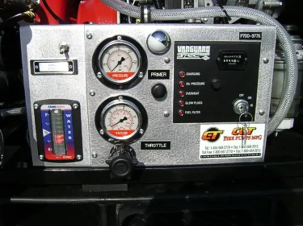 Exterior view of small fire truck showing cab, body compartments, and wheel/tire area.