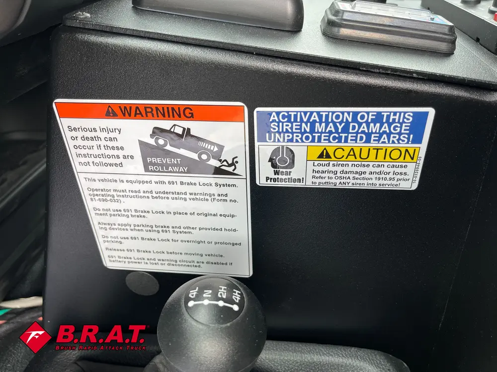 Dashboard warning labels and caution sticker on center panel.
