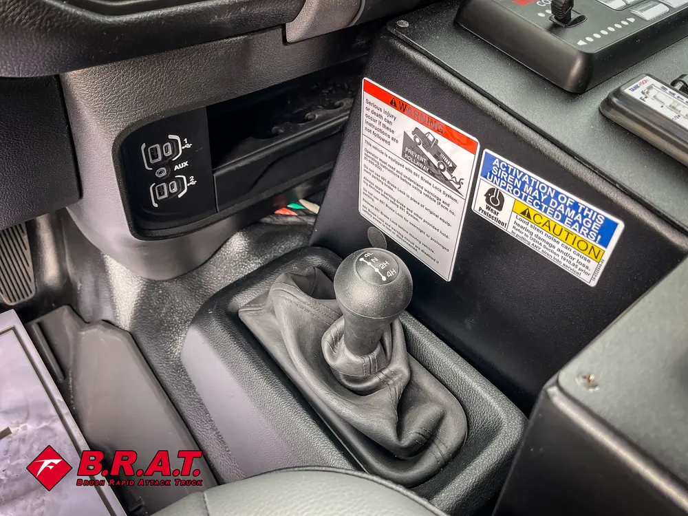 Manual floor shifter and dashboard control labels near passenger side.