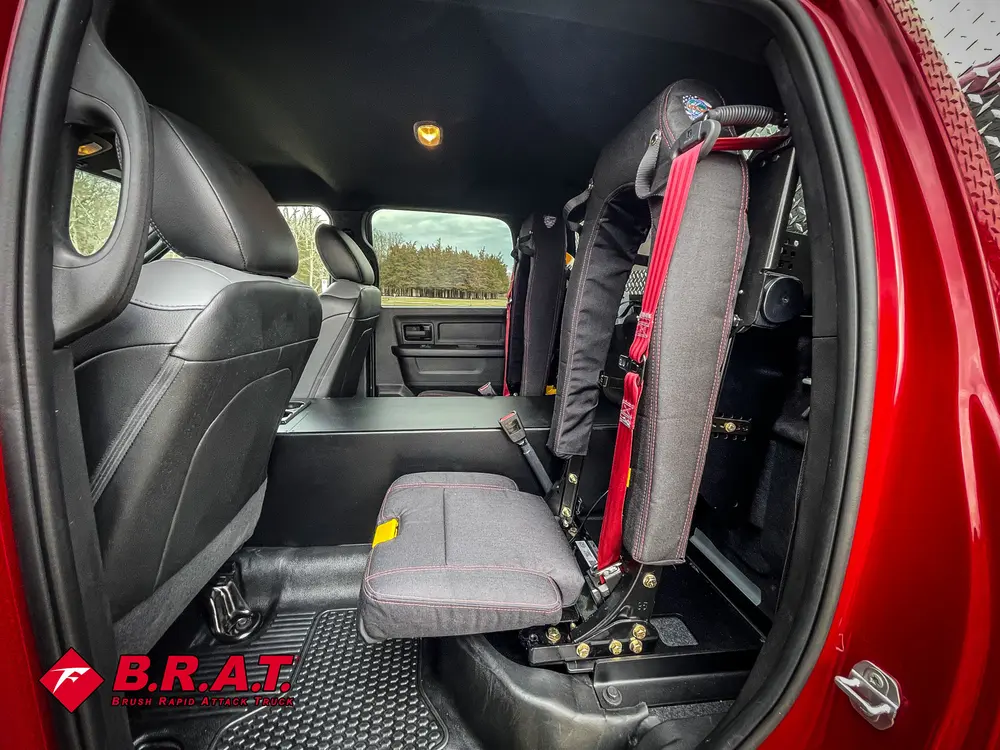 Open rear door view with side seat and mounted equipment bracket.