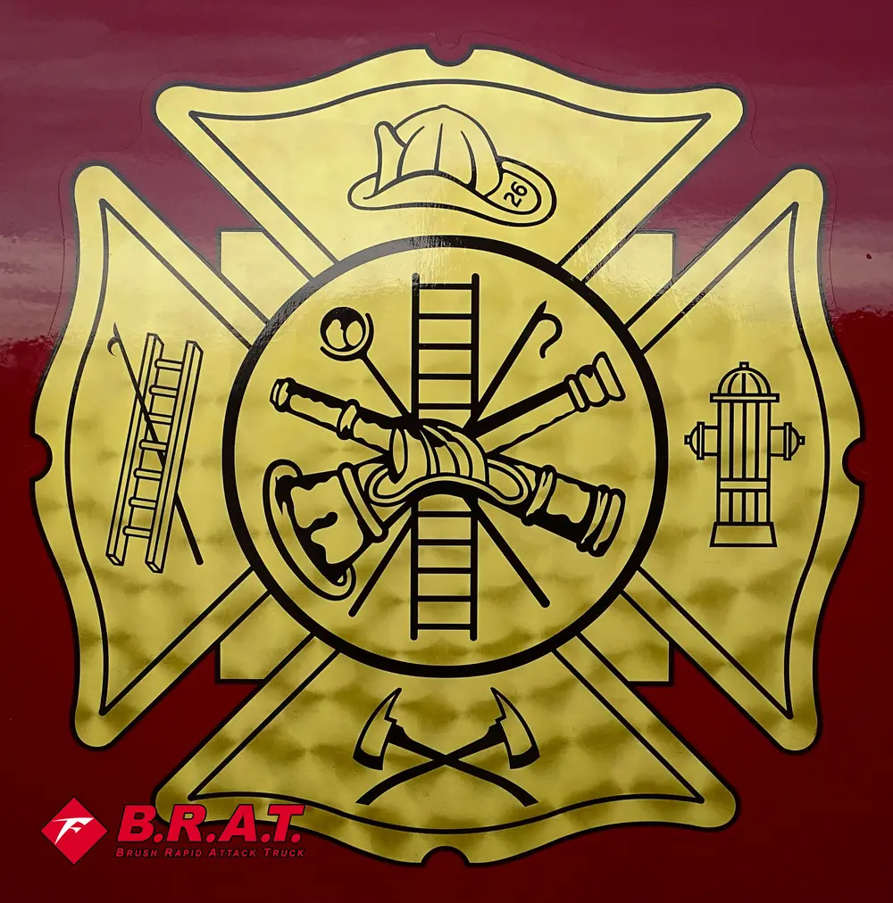 Gold fire department crest decal on red truck body panel.