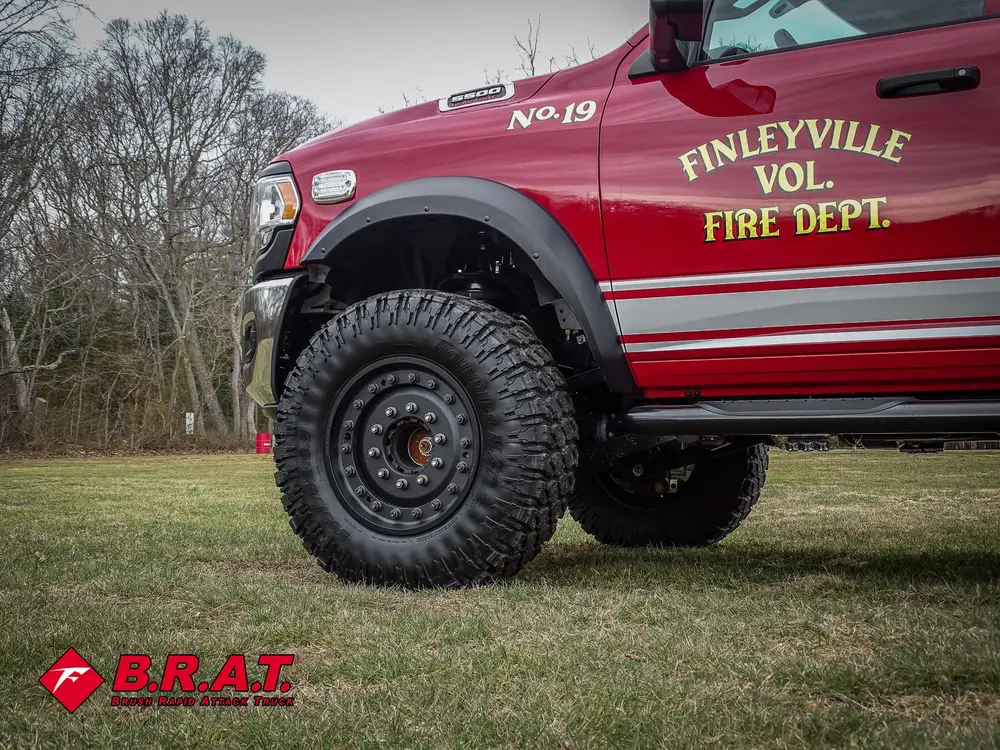 Front side body close-up with department lettering and wheel.