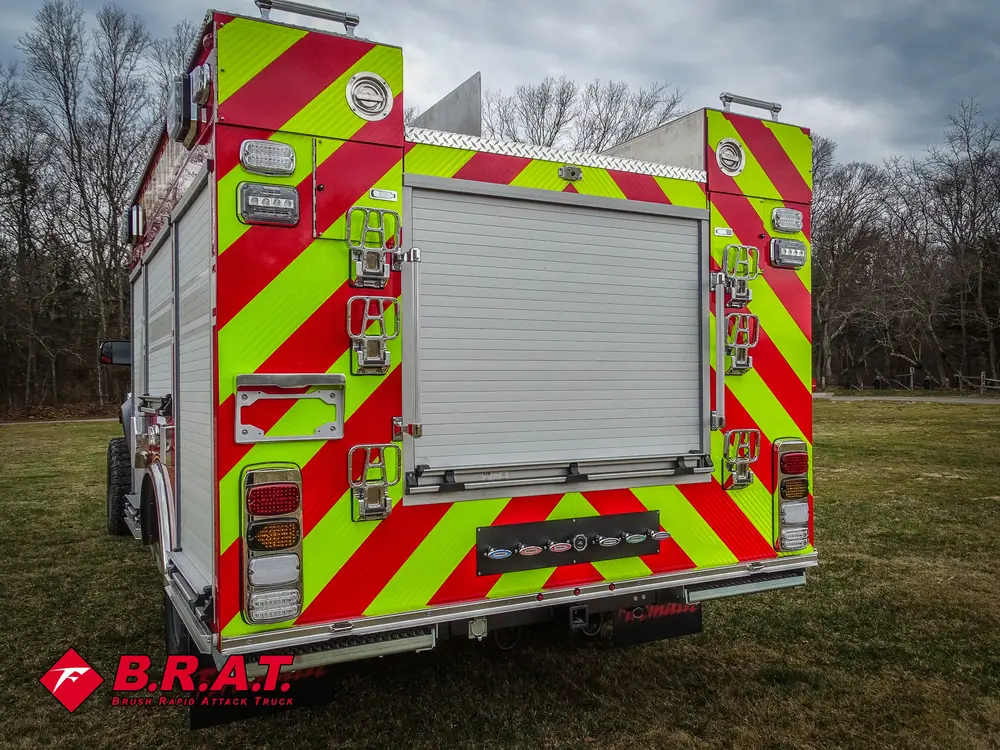 Straight rear view with closed roll-up door and chevron striping.