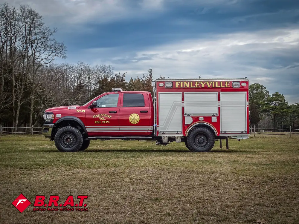 Full left-side profile of truck parked on grass.
