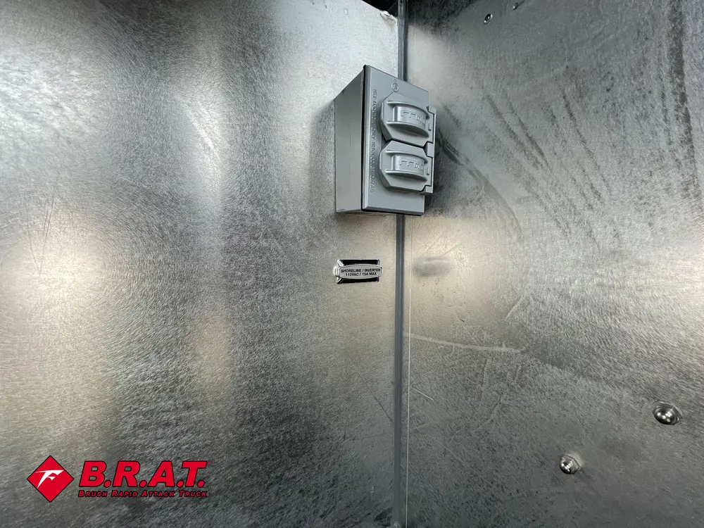 Compartment interior close-up with outlet box and wall mounts.