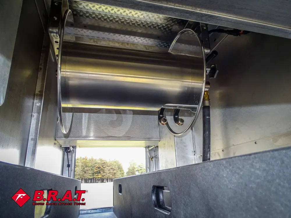 Compartment close-up with mounted metal hose reel.