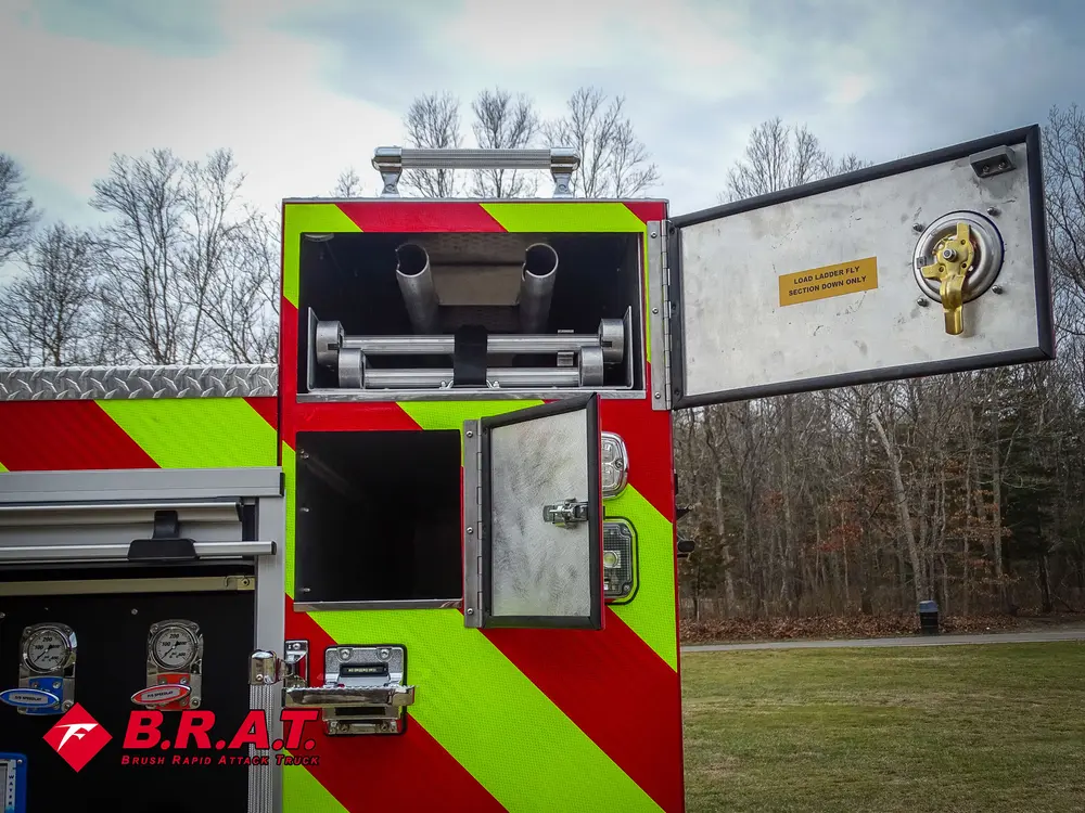 Rear center upper bay open with hose reel mechanism visible.