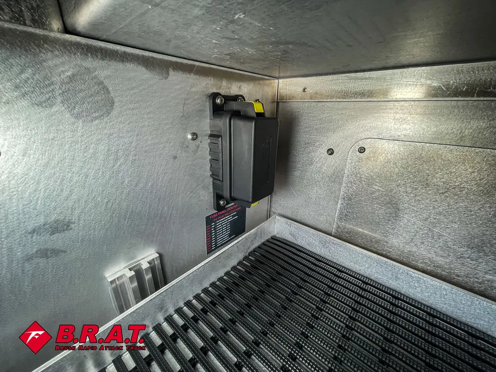 Inside corner of compartment with ribbed rubber floor and side panels.