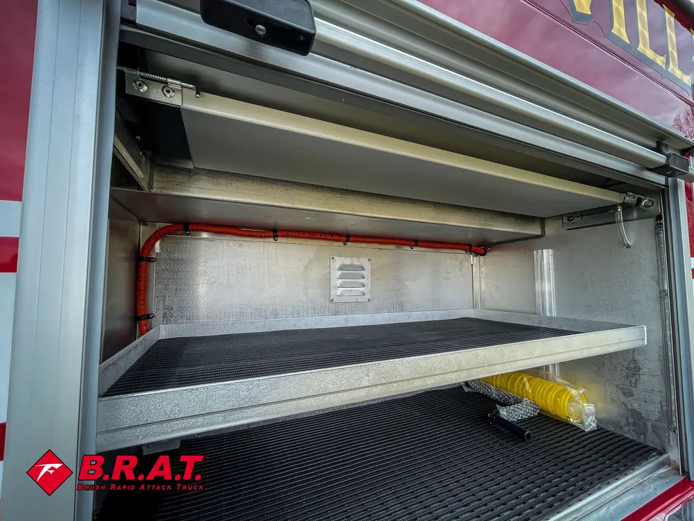 Deep side storage bay with stacked shelves and interior lighting.
