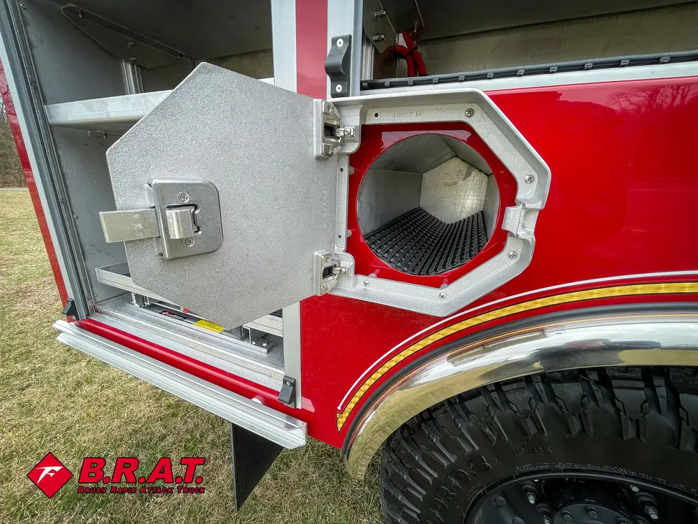 Round intake port behind a small side hatch above the rear wheel.