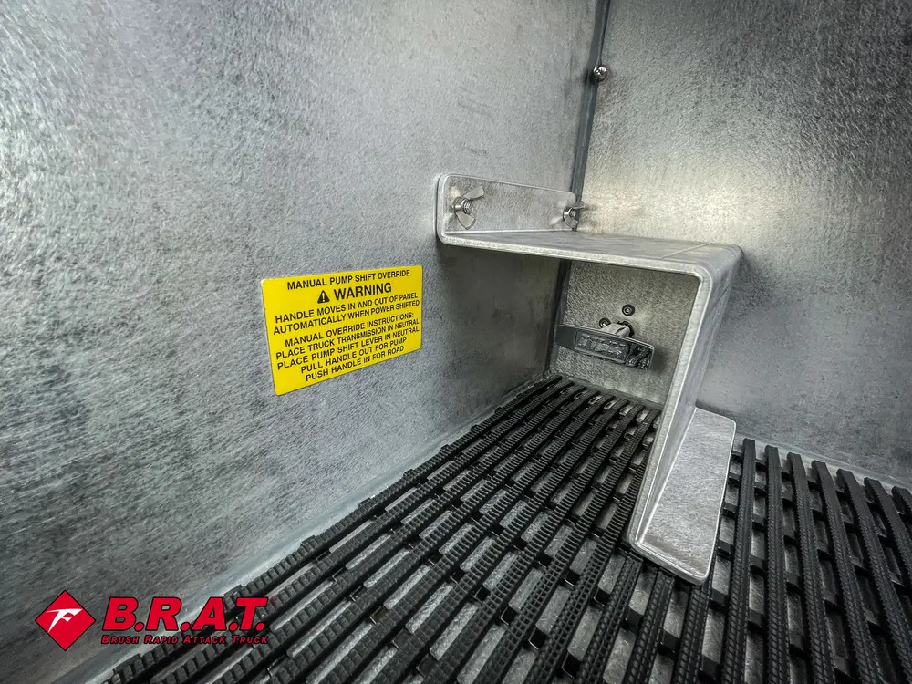 Close-up of compartment corner with yellow warning label and shelf bracket.