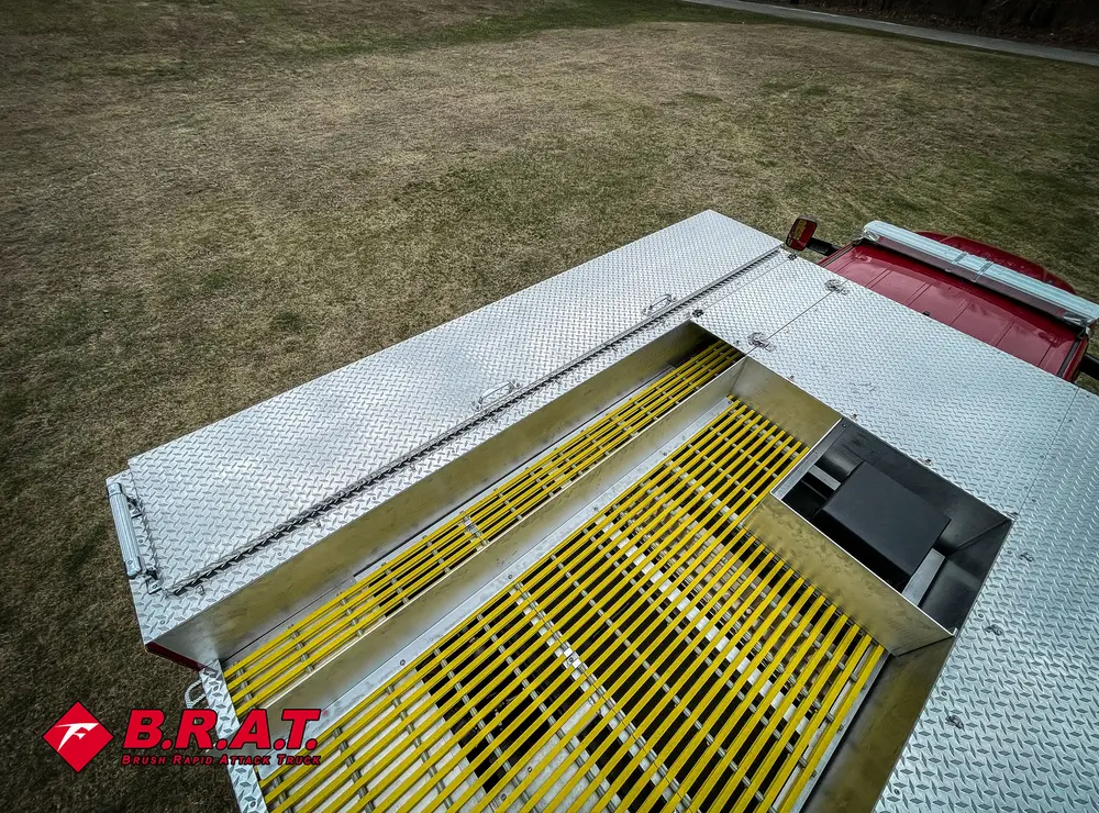 Rear deck hatch open over yellow anti-slip grate and diamond plate.
