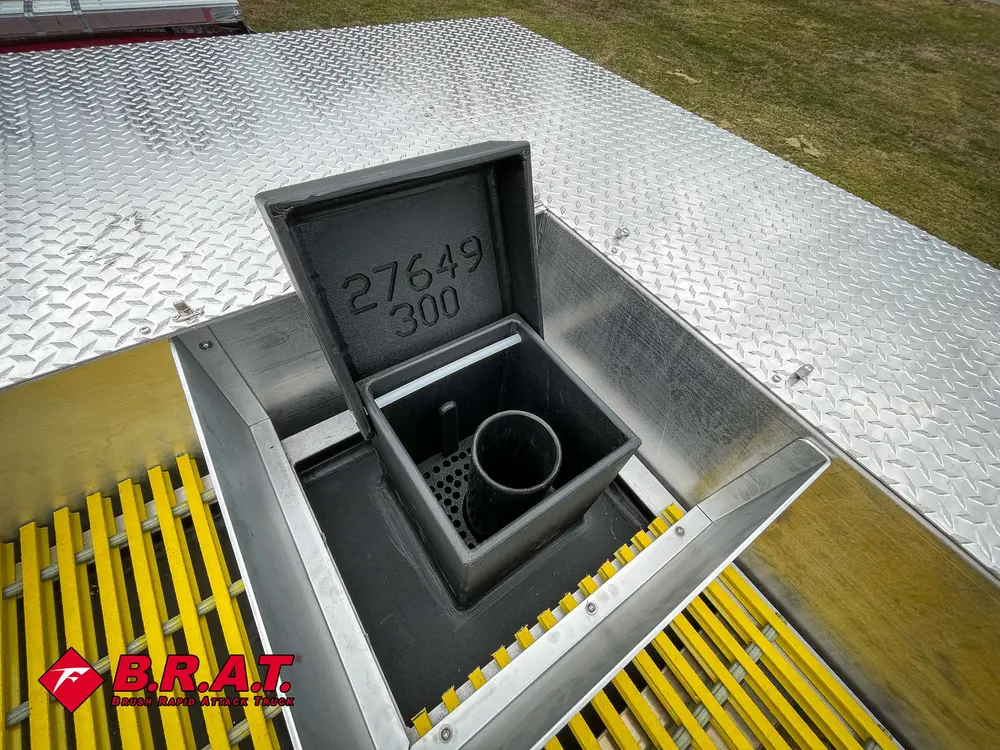 Small recessed utility bin with dual ports set into rear deck.