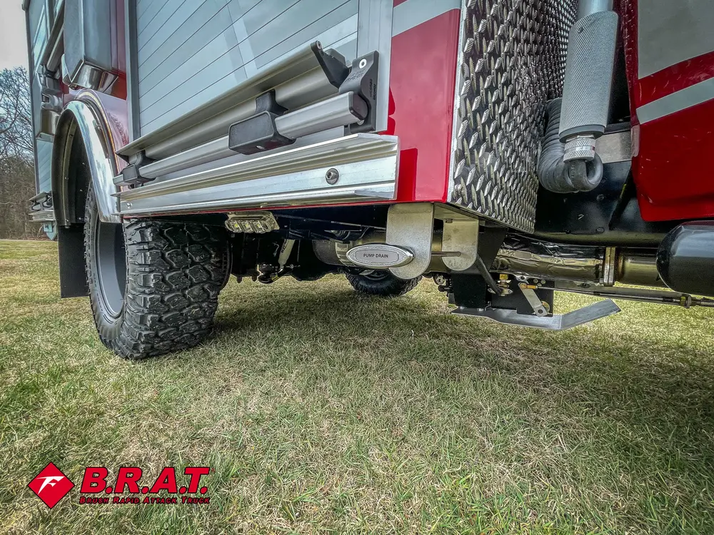 Low side angle showing step area and underbody near rear wheel.
