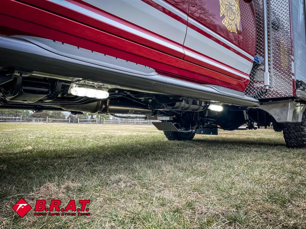 Ground-level view under body compartments and frame rails.