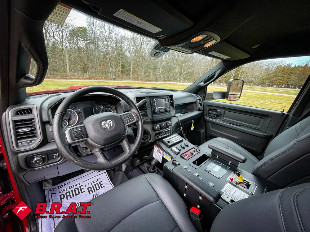 Driver cab interior wide shot with steering wheel and center console.