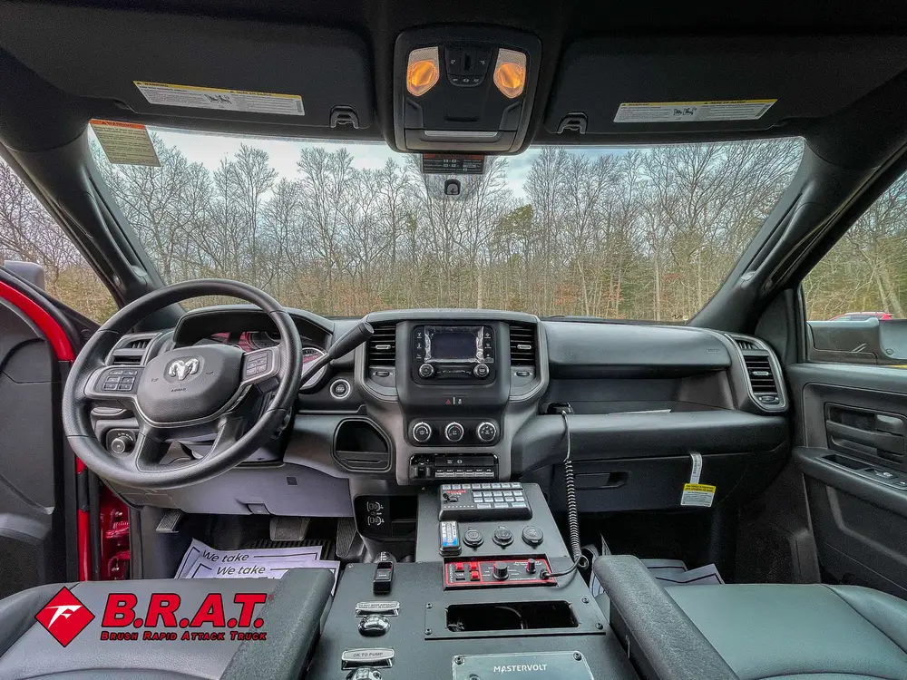 Front cabin view from rear seats showing dashboard and controls.