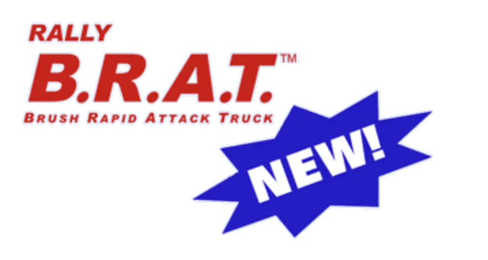 Exterior view of small fire truck showing cab, body compartments, and wheel/tire area.