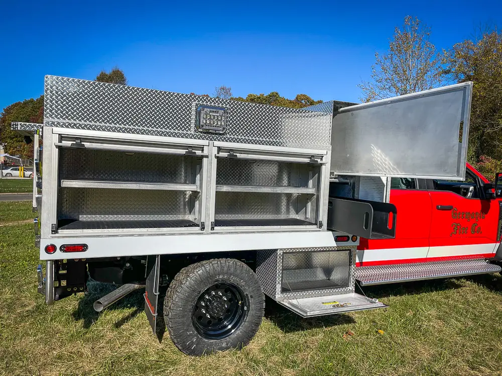 Wide right-side view with large compartment door raised.