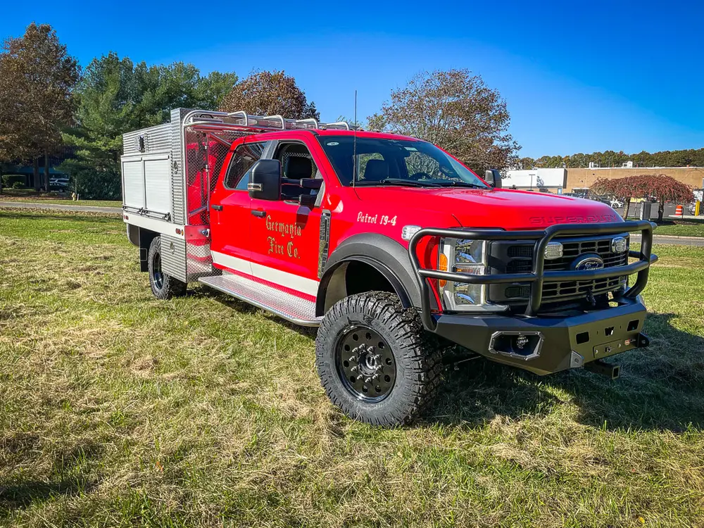 Front-left exterior with driver door open and side body visible.