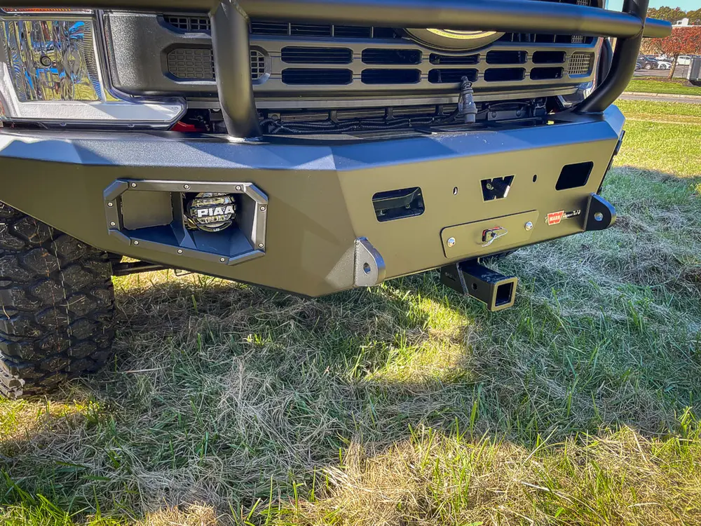 Front bumper close-up with off-road tire and tow point.