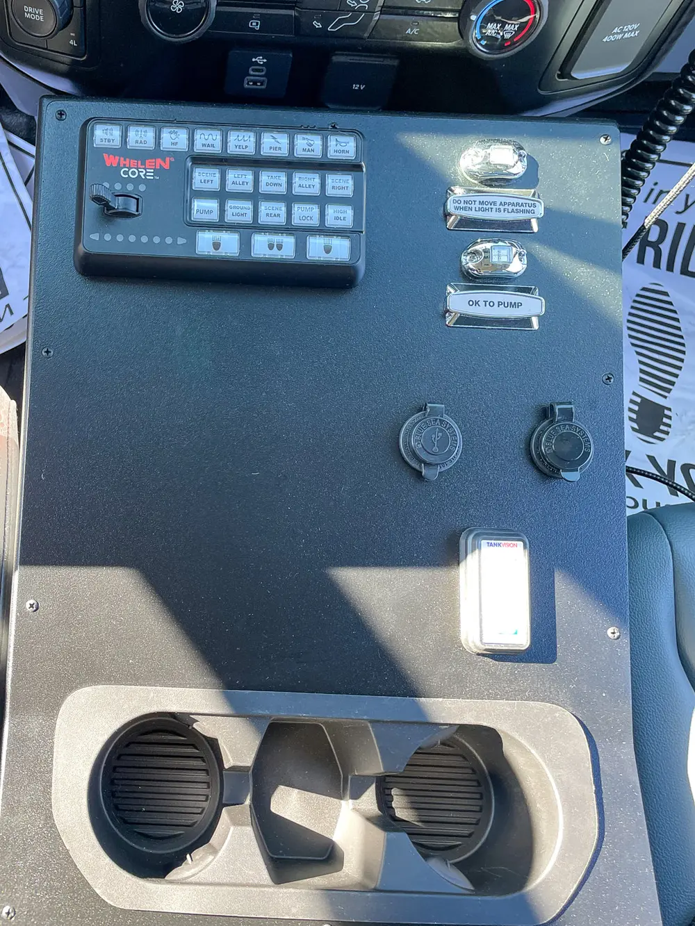 Interior side panel close-up with mounted switches and ports.