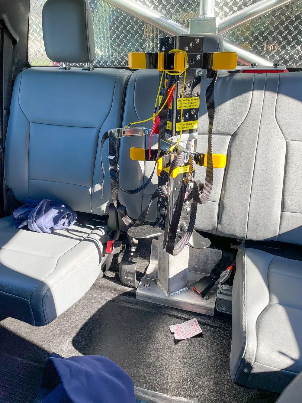 Rear seating close-up with mounted equipment bracket between seats.