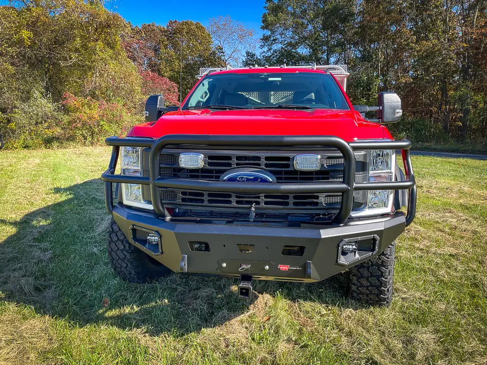 Head-on front view with brush guard and warning lights.
