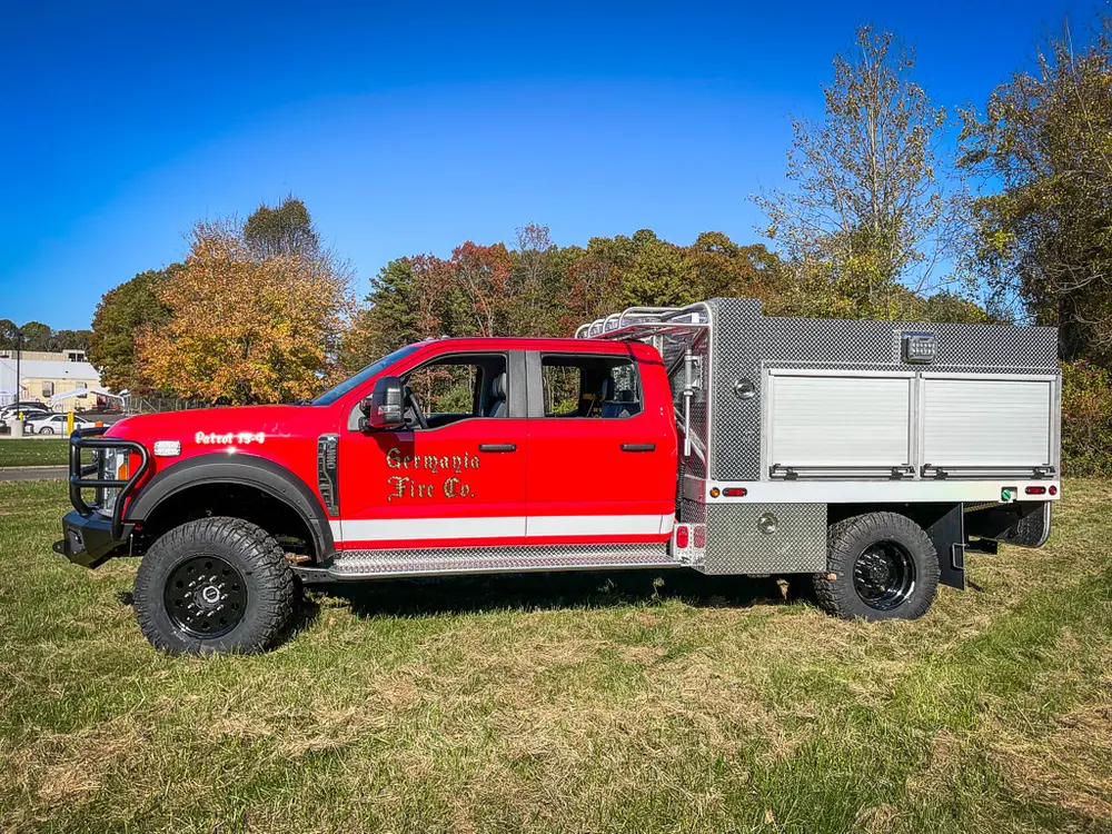 Full left-side profile with utility body and side compartments.