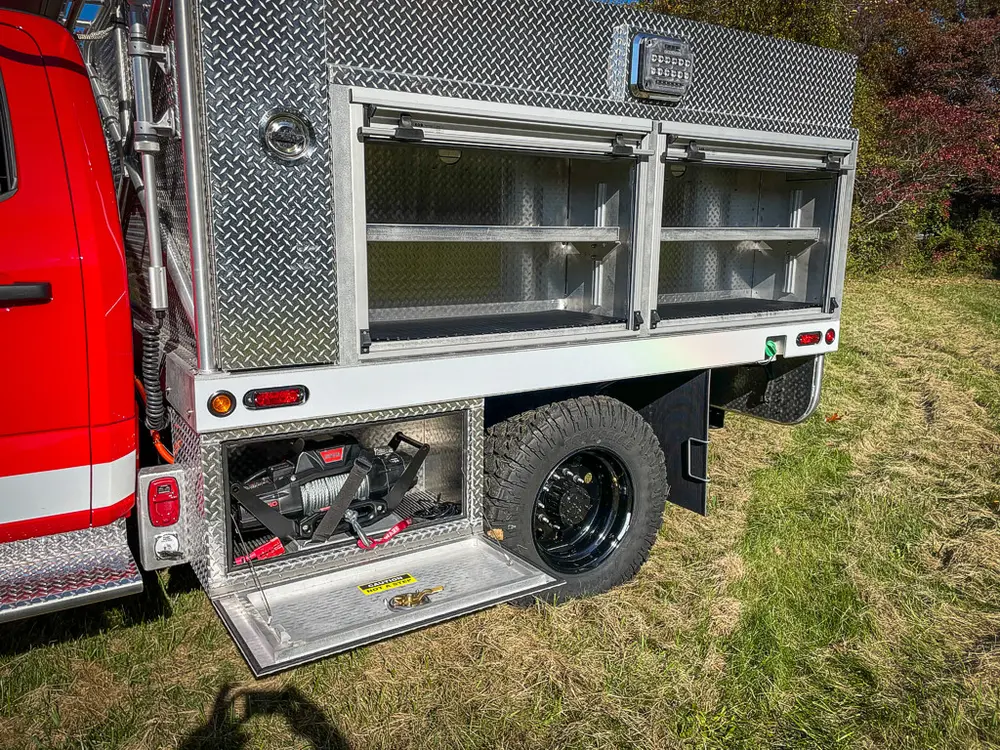 Rear side compartment open showing shelf storage and lower bay.