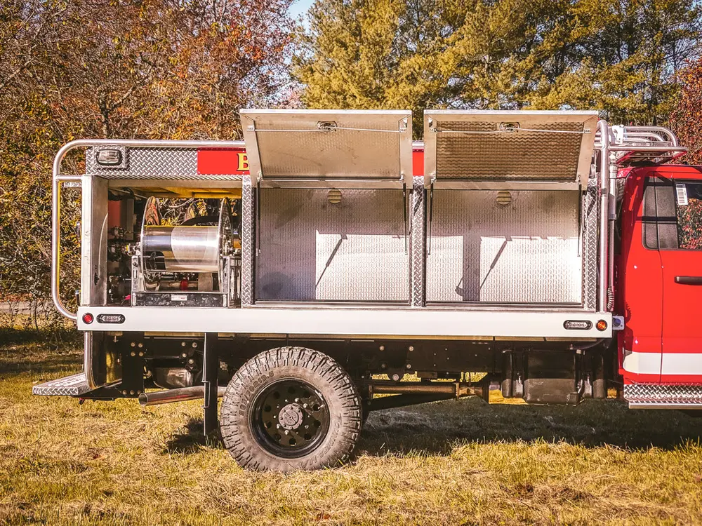 Open side compartments showing multiple shelf levels and tool bay.