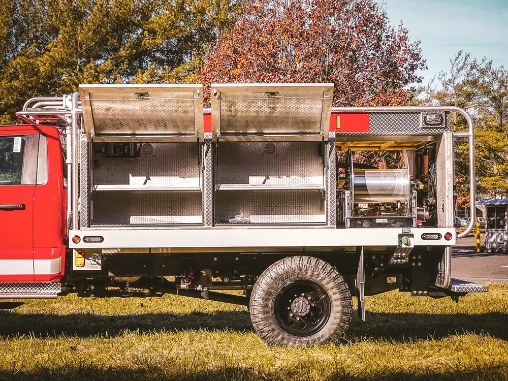 Rear-right side with upper compartment doors raised and shelves visible.