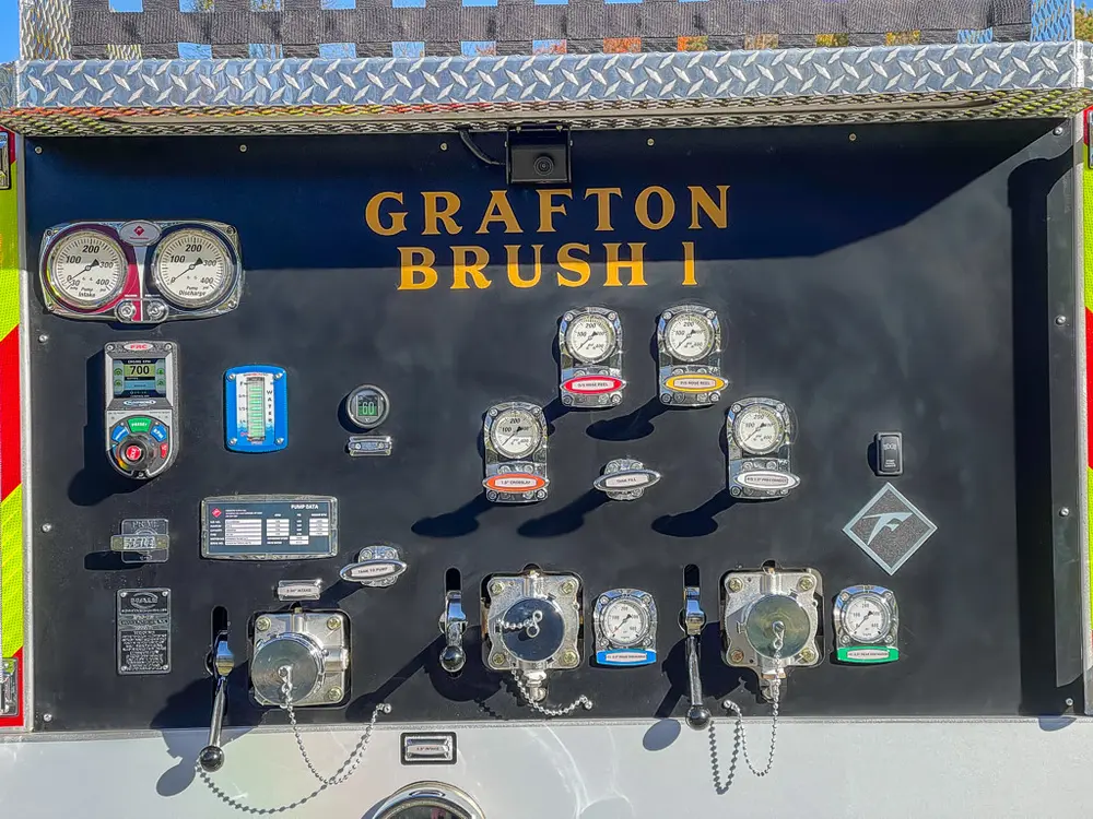 Rear pump panel close-up with gauges, valves, and labels.