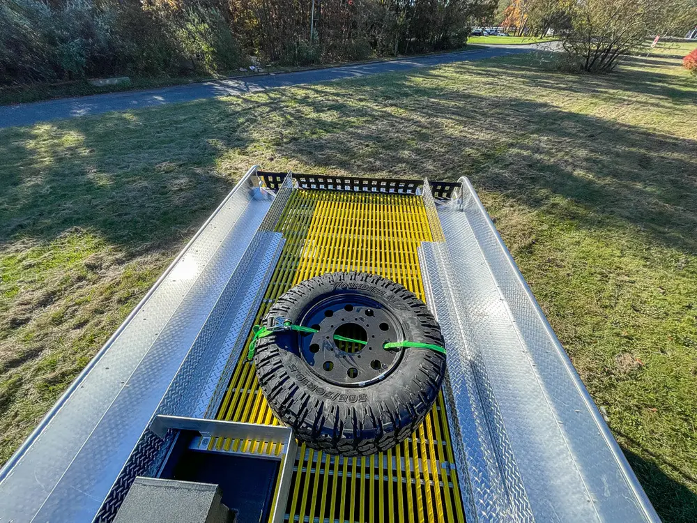 Top deck view toward rear with spare tire centered on grate.