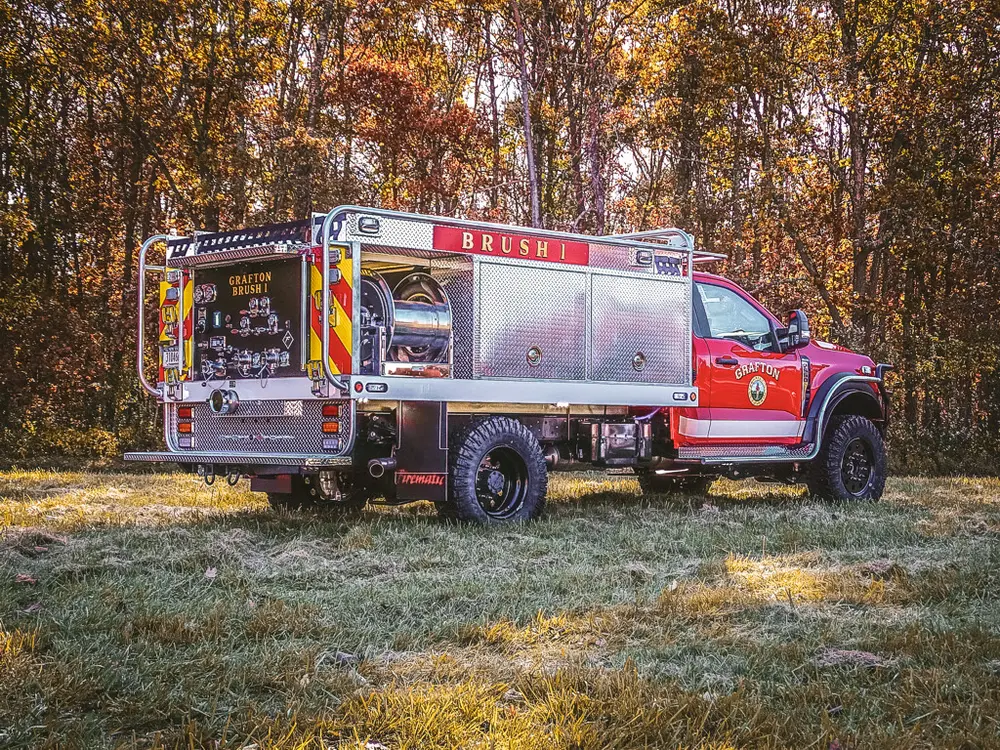 Rear-left three-quarter view showing pump panel and side compartments.