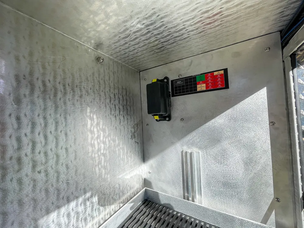 Compartment wall close-up with mounted control/charger unit.