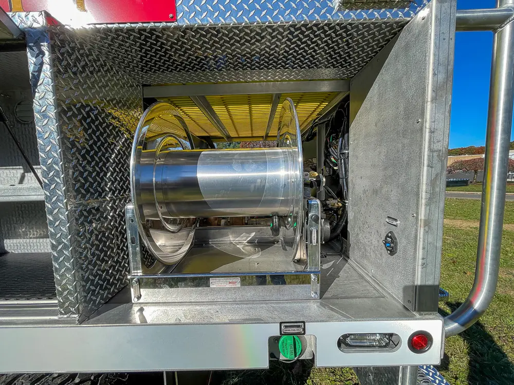 Rear side bay view with hose reel and compartment frame.