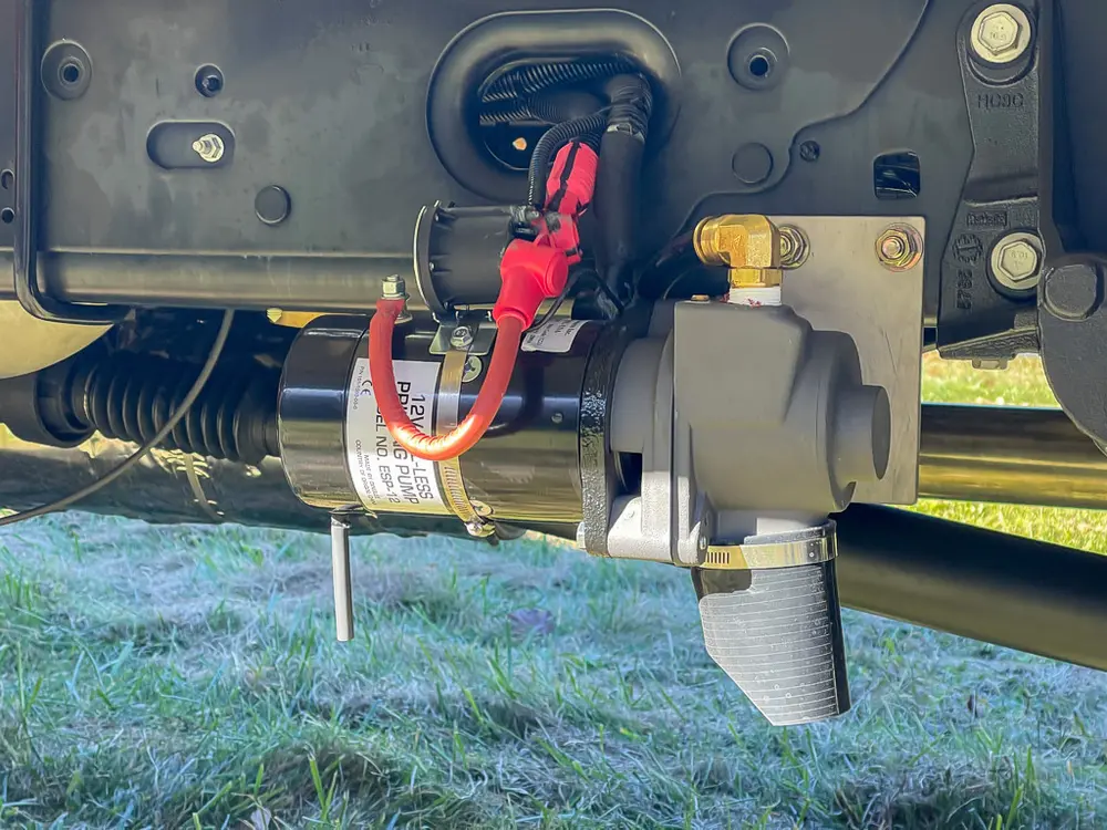 Underbody side close-up with mounted red connector and electrical hardware.