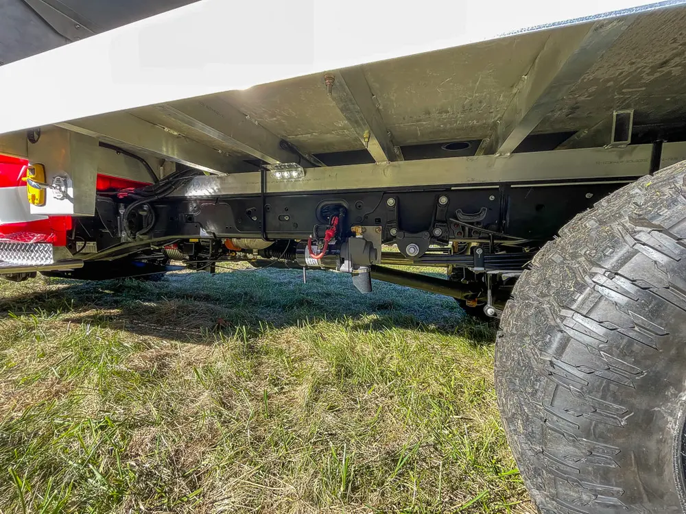 Underside chassis view showing frame and suspension components.