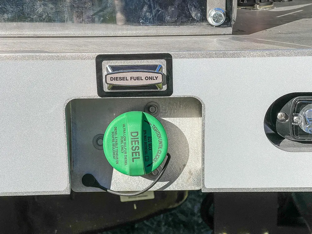 Diesel fill cap and side fuel door close-up on utility body.