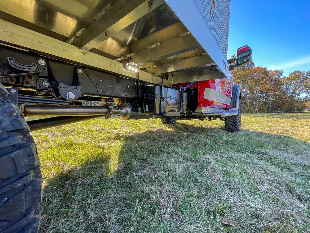 Low side undercarriage view showing frame rails and axle components.