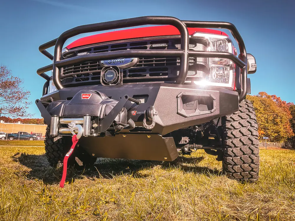 Low front-left exterior angle with grille guard and winch bumper.
