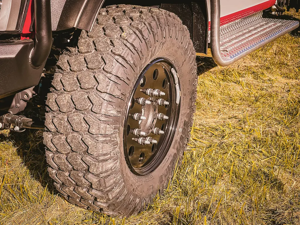 Front wheel and tire close-up showing aggressive tread pattern.