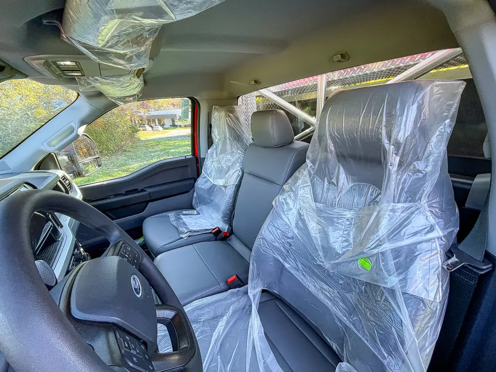 Passenger-side interior view with front and rear seats visible.
