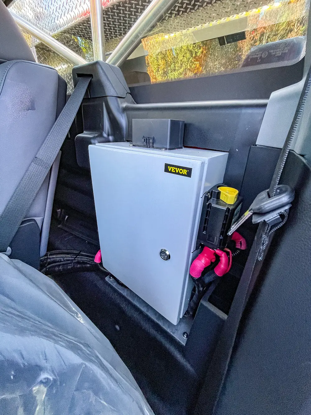 Center-floor mounted control box and hardware behind front seats.