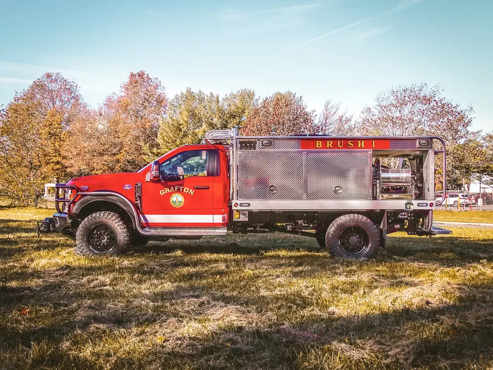 Full right-side profile of truck parked on grass.