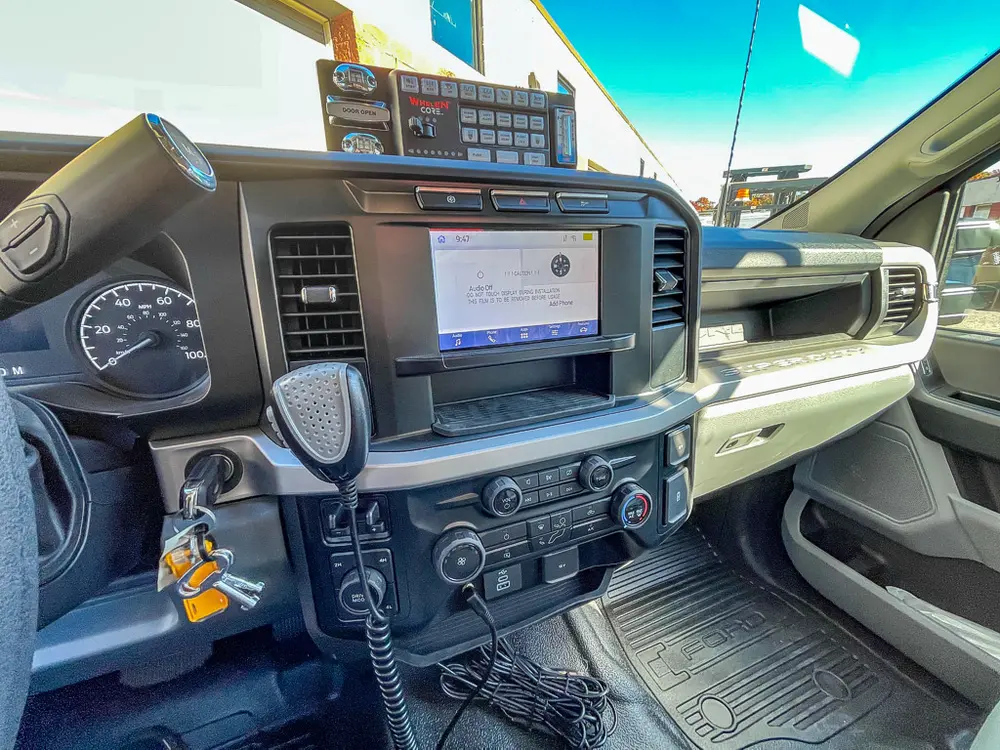 Wide passenger-side dashboard view with mounted radio/display unit.