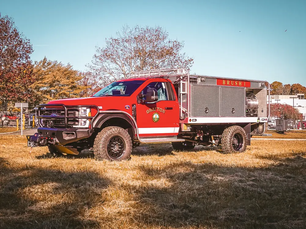 Front-left exterior view with driver door open and raised stance.